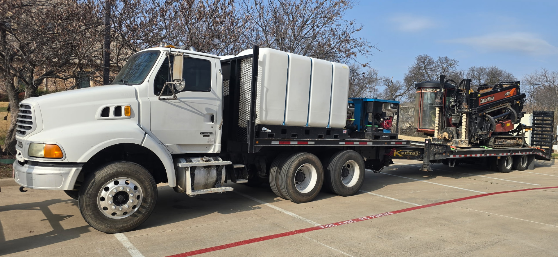 True Bore Solutions flatbed truck carrying drilling fluid tanks and mixing equipment